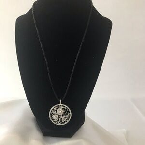 Crystal look pendant on thin black silk rope